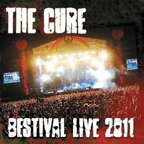 Stage with 'The Cure' and 'Bestival Live 2011' text, crowd in front